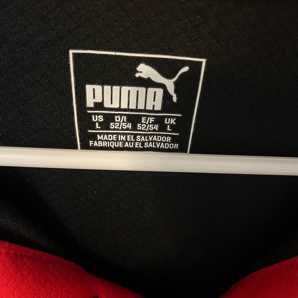Black and red Puma gold shirt.